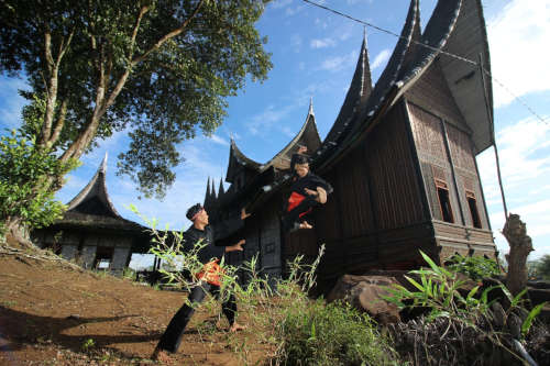 Two men performing Silek, a local martial art
